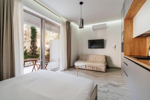 a bedroom with a bed and a living room at Aura Tower Aparments by In Property in Rafailovici