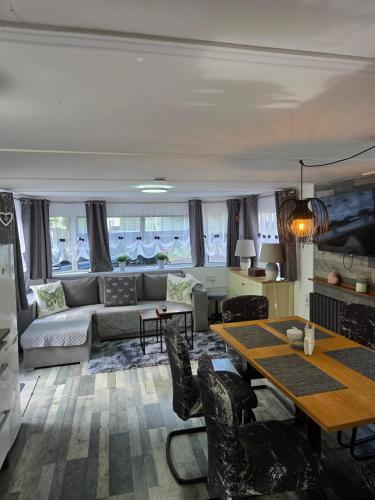a living room with a couch and a table at Unique Caravan with Outdoor Space in Ballantrae