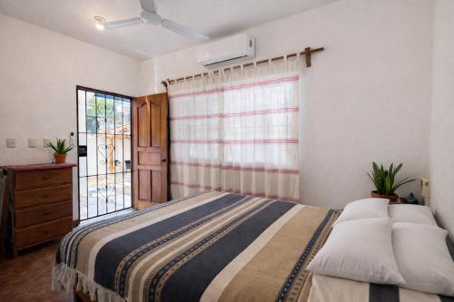a bedroom with a large bed and a window at Casa Alma in Brisas de Zicatela