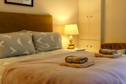 a bedroom with a bed with two towels on it at Spacious cottage - walk to Crieff in Crieff