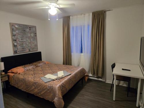 a bedroom with a bed with two books on it at Brossard home in Brossard