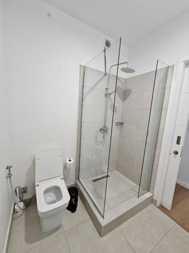 a bathroom with a glass shower and a toilet at Opatio residence 1314 in Tamarin