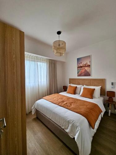 a bedroom with a large bed and a window at Opatio residence 1314 in Tamarin