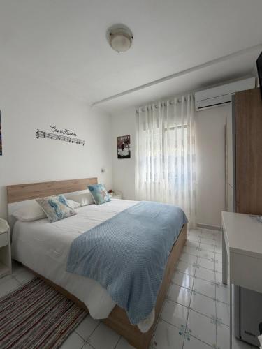a bedroom with a large bed and a window at Capri Melody in Anacapri