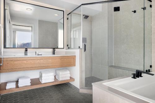 a bathroom with a tub and a sink and a shower at Salt Lake City Marriott University Park in Salt Lake City