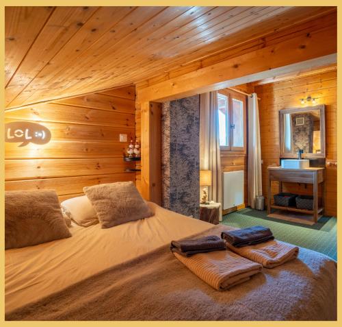 a bedroom with a large bed in a wooden room at Olaf Chalet IT5 I Les Gets in Les Gets
