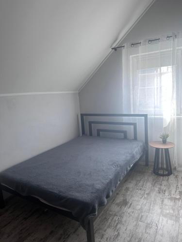 a bedroom with a bed and a table and a window at SeaLine Odessa in Kryzhanivka