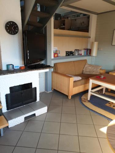 a living room with a couch and a fireplace at Ferienhaus 52 in Kirchheim