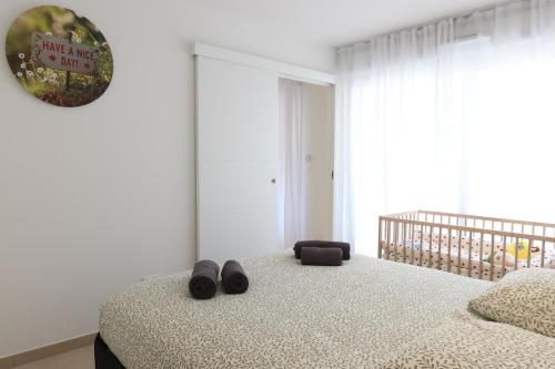 a bedroom with a bed with shoes on it at Nice Time - Chic Apartment with sunny terrace, Nice Port in Nice