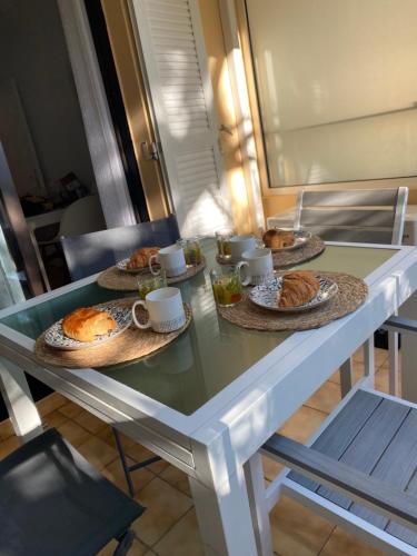 a table with three plates of food on it at Coudou Beach T2 cosy à 2 pas de la mer in Six-Fours-les-Plages