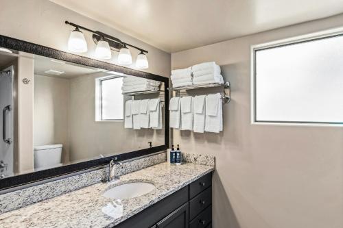 a bathroom with a sink and a mirror at Starr Pass Golf Suites in Tucson
