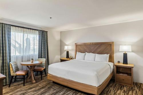 a hotel room with a bed and a table at Starr Pass Golf Suites in Tucson
