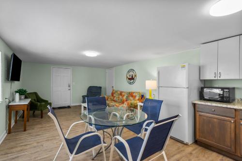 a kitchen and a dining room with a table and chairs at Sand Dollar Suites 2 in Carolina Beach