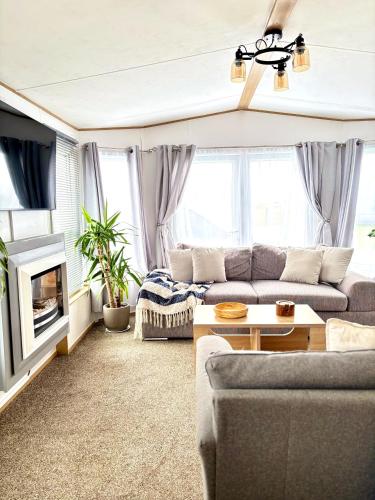 a living room with a couch and a table at Seven Bays Hideaway in Saint Merryn