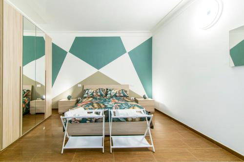a bedroom with a bed and a geometric wall at ANTONELLI Apartment L'AQUILA in LʼAquila