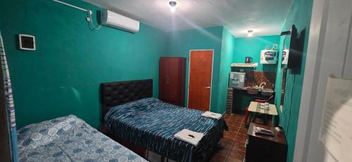 a small room with a bed and a mirror at Apart Fiambala alojamiento in Fiambalá