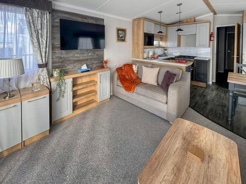 a living room with a couch and a table at Bordeaux in Heysham
