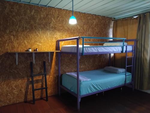 a room with two bunk beds and a table at Casa Retro Acacias Hostel in Acacías