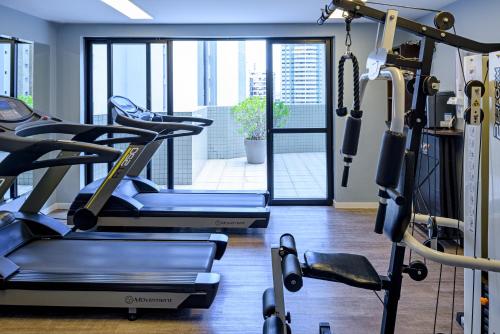 a gym with cardio equipment and a view of the city at Rio Hotel by Bourbon Batel - Curitiba in Curitiba