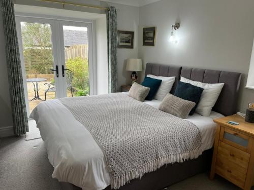 a bedroom with a large bed with a window at Tresithick Vean Bed and Breakfast in Truro