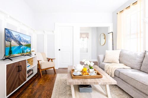 a living room with a couch and a tv at The Santiago Yale New Haven with Parking and Modern in New Haven
