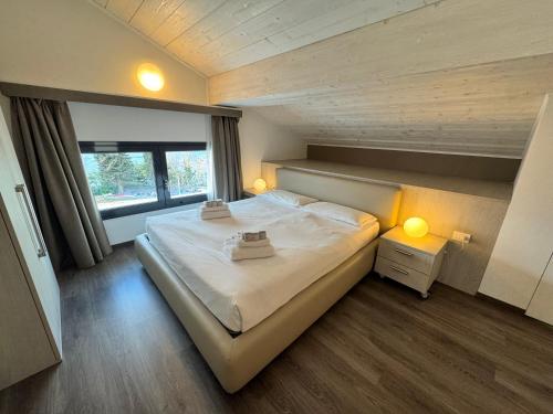 a bedroom with a large bed and a large window at Residenza Decimina in Varenna