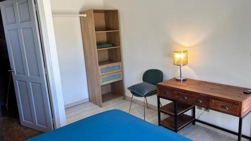 a bedroom with a desk and a chair and a table at Tropical Suite Direct Pool Access & Garden View in Baie-Mahault