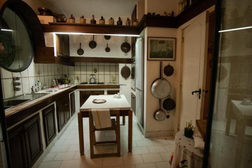 a kitchen with a table and a kitchen with pots and pans at Complesso Villa Le Palme in Forio d'Ischia