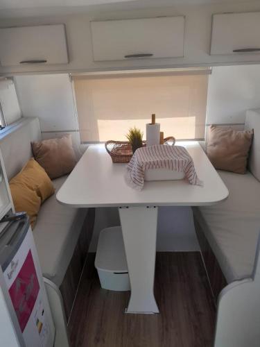 a small white table in the middle of a caravan at Trailer cassa Rodante in Posadas