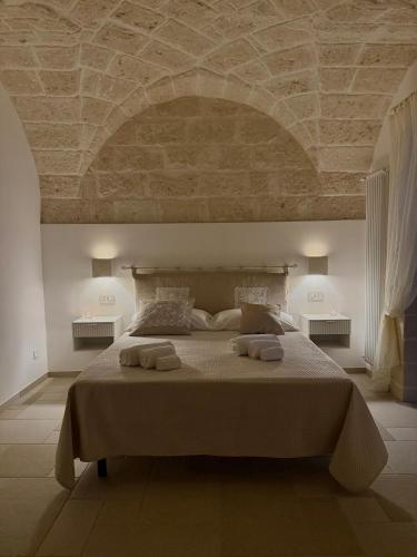a bedroom with a large bed with a stone ceiling at Samy Suite in Fasano