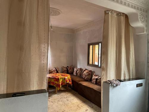 a living room with a couch and a table at Atlas House in Amizmiz