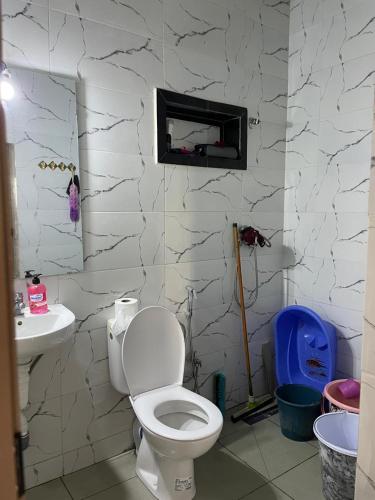 a bathroom with a toilet and a sink at Atlas House in Amizmiz