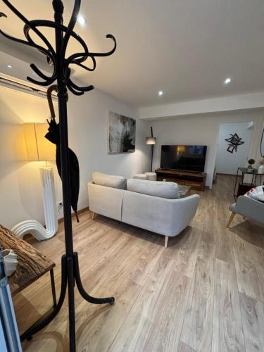 a living room with a white couch and a fireplace at Appartement Ajaccio T3 in Ajaccio