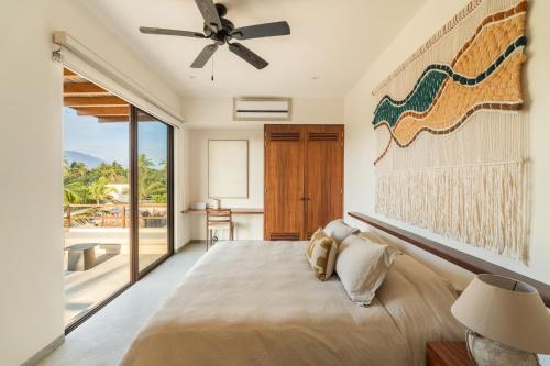 a bedroom with a bed and a ceiling fan at Casita VR08 in Zihuatanejo