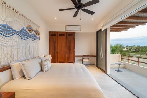 a bedroom with a large bed and a balcony at Casita VR09 in Zihuatanejo