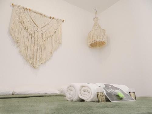 a white wall with a towel and a hanging decoration at We playa Hotel - Adults Only in Playa del Carmen