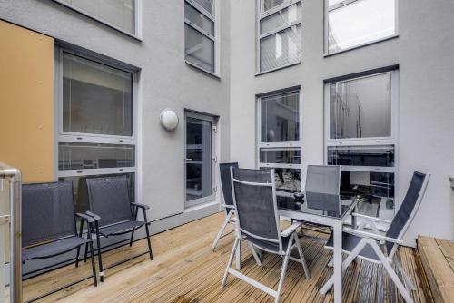 a balcony with chairs and a table in front of a building at 5 Mins Walk to Moorgate, Tranquil City Retreat in London