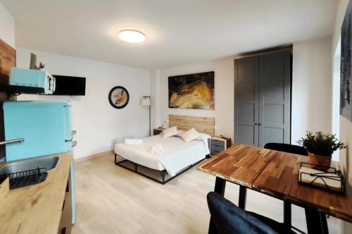 a bedroom with a bed and a table in a room at Elite Muralla Lugo Experience 2.1 in Lugo