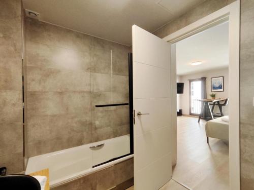 a bathroom with a shower and a glass door at Suite imperial Muralla de Lugo 2.2 in Lugo