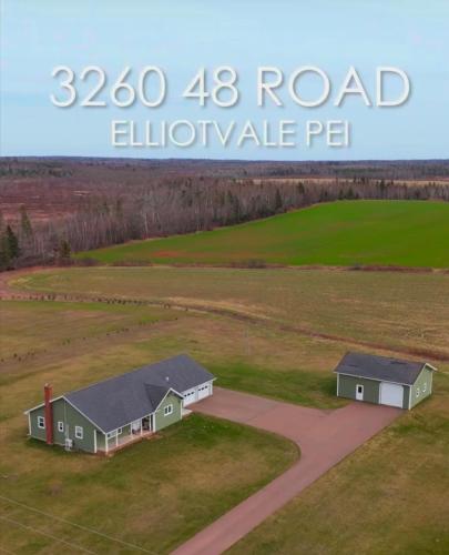 an aerial view of two houses in a field at Small Town Bound Inn in Vernon River