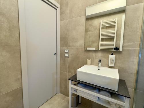 a bathroom with a white sink and a mirror at Vesta Motel in Vieste