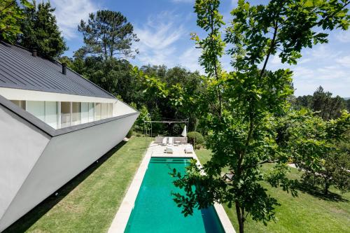 a swimming pool in the backyard of a house at Slope Design Villa - Architecture villa with private pool in Ponte de Lima