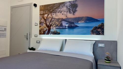 a bedroom with a large painting above a bed at Vesta Motel in Vieste