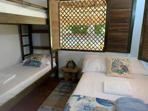 a room with two bunk beds and a window at La Coralina azul in San Bernardo del Viento