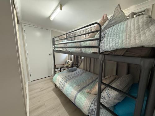 a bedroom with two bunk beds and a bed at Hideaway on King in Urangan