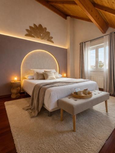 a large bedroom with a large bed and a table at VILLA PANGEA Habitaciones Boutique - Camino del Norte - Castro Urdiales in Castro-Urdiales
