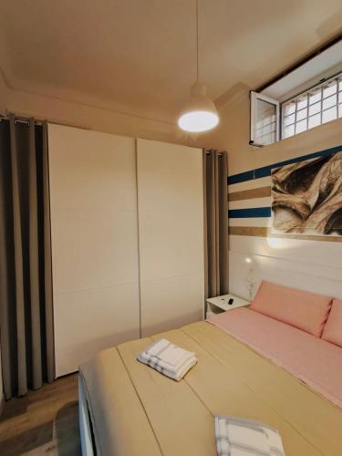 a bedroom with a bed with two towels on it at La Corte di Noto in Noto