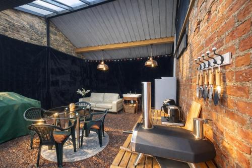 a room with a table and chairs and a brick wall at Linden Lodge at Lough Sillan House - Dog-friendly - Adults only in Shercock