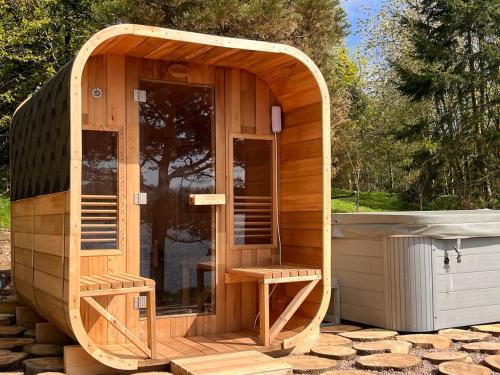 a large wooden sauna with a wooden arch over it at Linden Lodge at Lough Sillan House - Dog-friendly - Adults only in Shercock