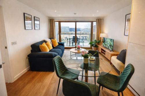 a living room with a couch and chairs and a table at GreenGage Tree Stylish 2 Bedroom with Balcony & Parking in Cambridge